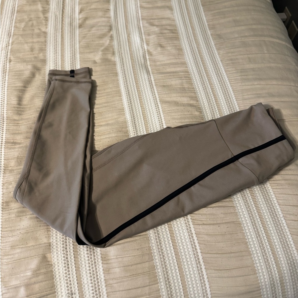 Women’s tan leggings with black stripe